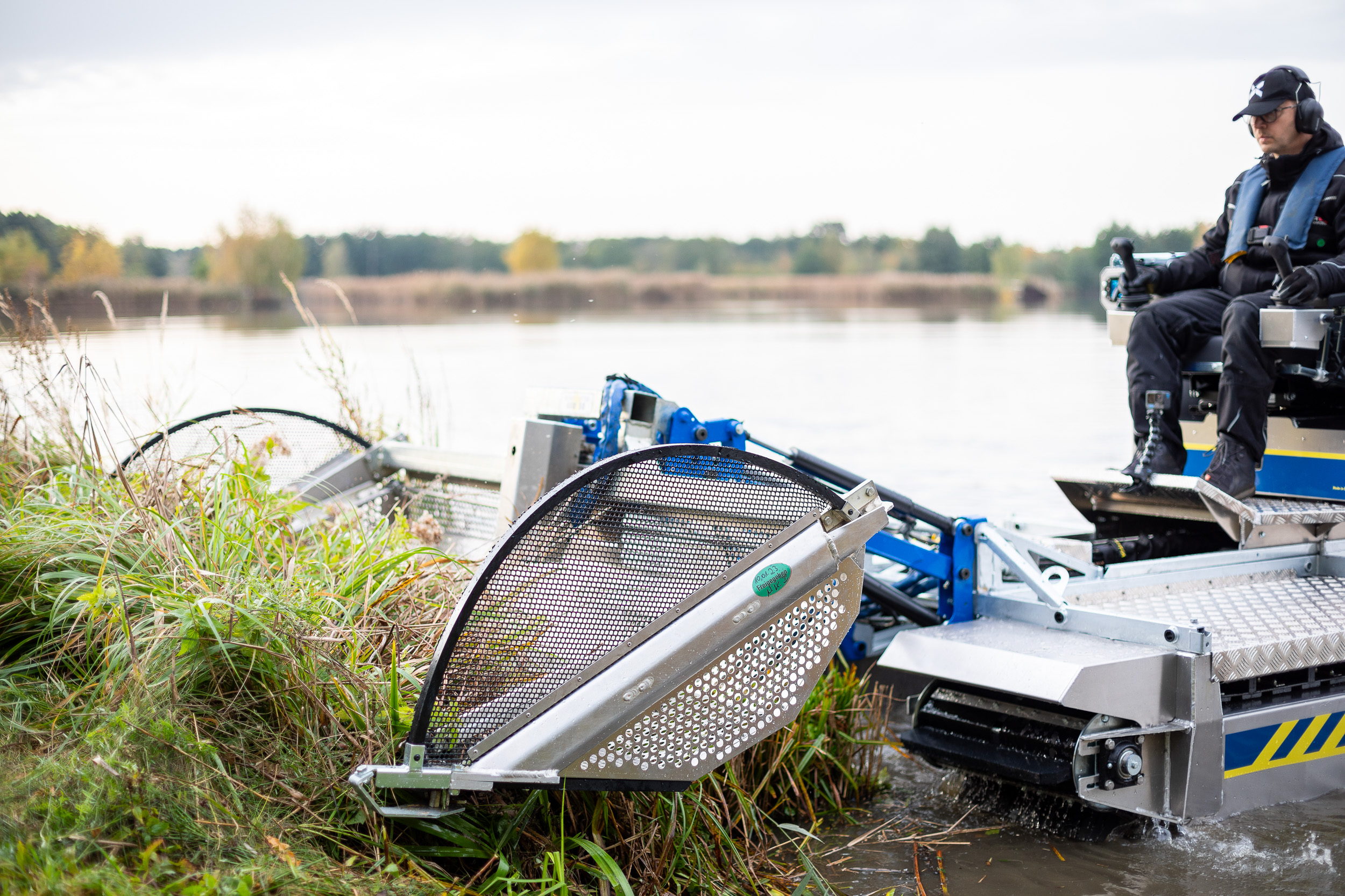 Professional equipment operating in pond cleanup